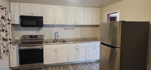 kitchen featuring white cabinets, dark hardwood / wood-style flooring, stainless steel appliances, and sink