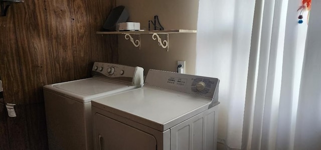 clothes washing area with independent washer and dryer