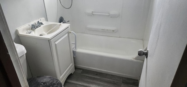 bathroom with hardwood / wood-style floors, vanity, and a washtub