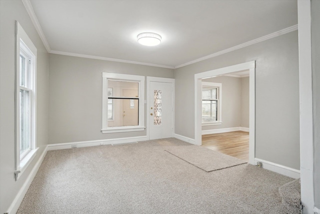 carpeted spare room with crown molding