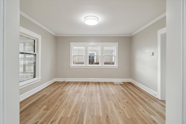 empty room with crown molding and light hardwood / wood-style flooring