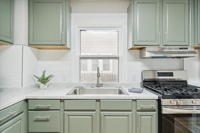 kitchen with tasteful backsplash, gas range, extractor fan, sink, and green cabinetry