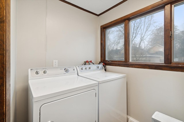 laundry room featuring washer and dryer and crown molding