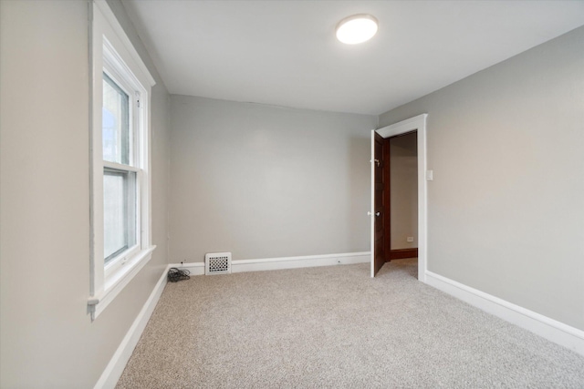 carpeted spare room with a wealth of natural light