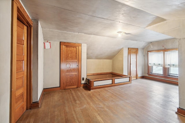 bonus room featuring light hardwood / wood-style floors and lofted ceiling