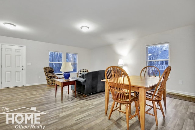 dining space with hardwood / wood-style flooring