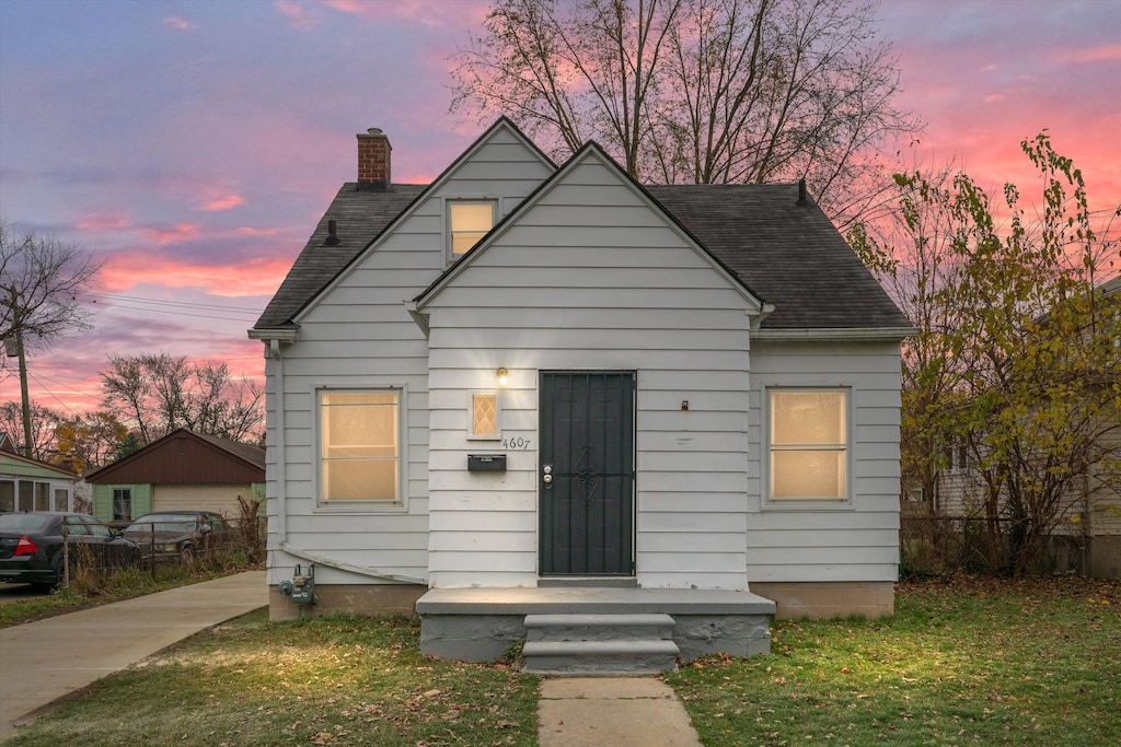 bungalow-style house with a yard