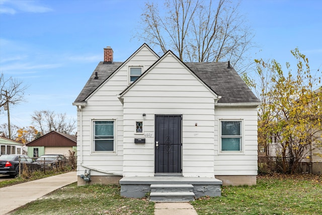 bungalow-style home featuring a front lawn