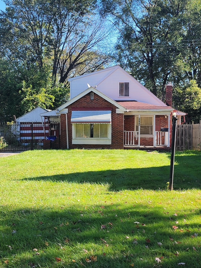 rear view of house featuring a lawn