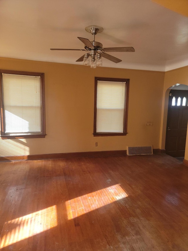 foyer entrance featuring hardwood / wood-style floors, ceiling fan, and a wealth of natural light