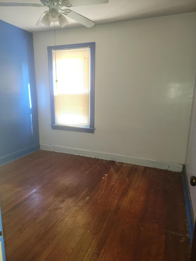 unfurnished room with dark hardwood / wood-style floors and ceiling fan