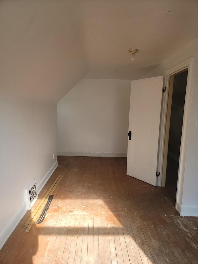 bonus room featuring dark hardwood / wood-style flooring and lofted ceiling