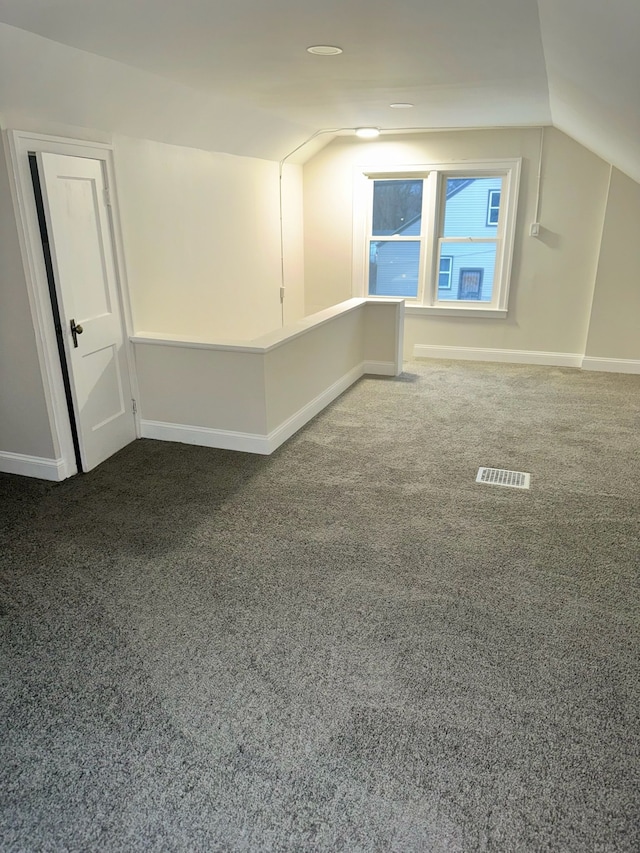 bonus room featuring carpet flooring and vaulted ceiling