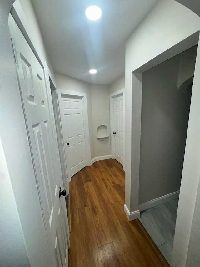 corridor featuring dark wood-type flooring