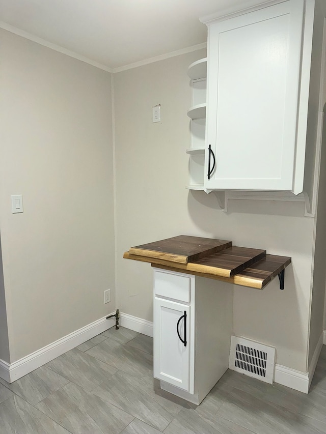 kitchen with white cabinets and ornamental molding