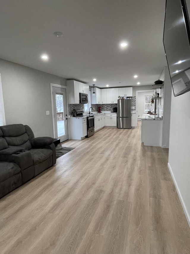 living room featuring light hardwood / wood-style floors and sink