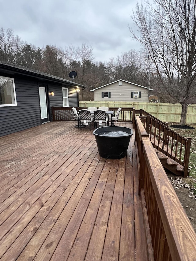 wooden terrace with a fire pit