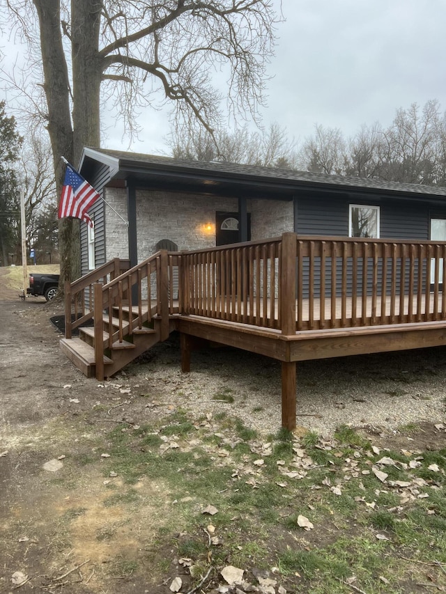 back of house featuring a wooden deck