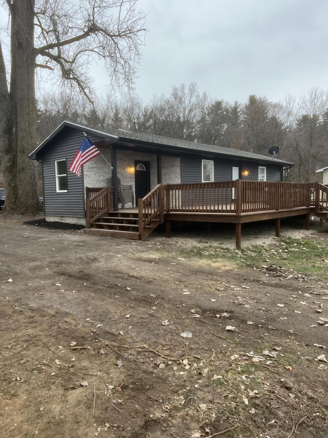 back of house featuring a wooden deck