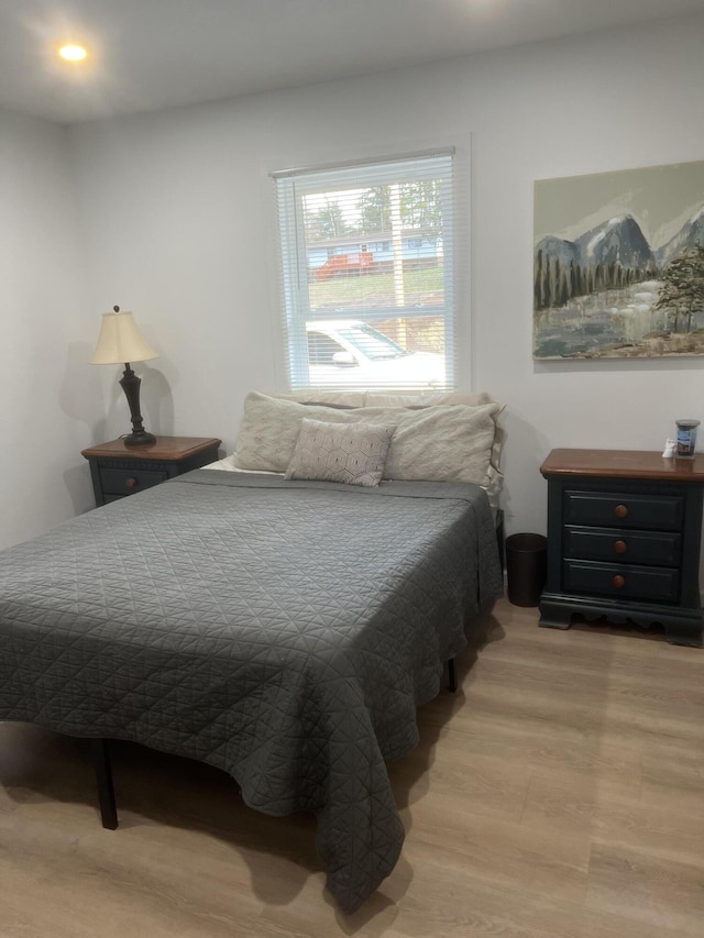 bedroom with hardwood / wood-style floors