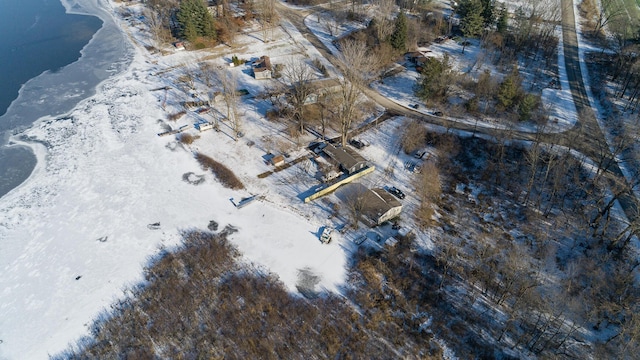 snowy aerial view featuring a water view