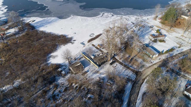 snowy aerial view featuring a water view