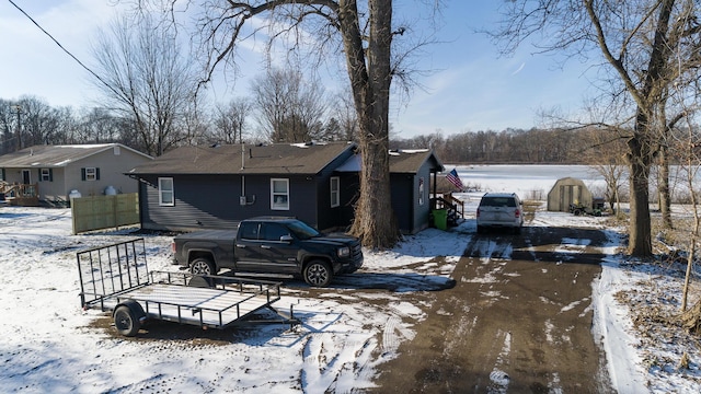 view of snow covered rear of property