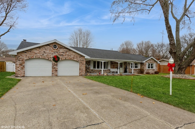 ranch-style house featuring a porch, a garage, and a front lawn