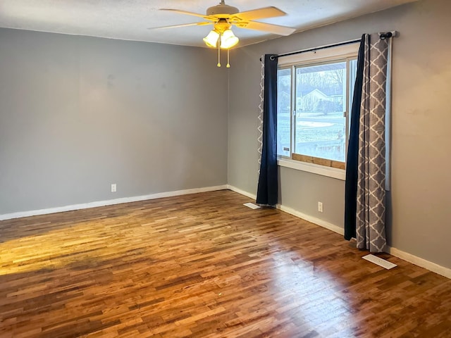 empty room featuring hardwood / wood-style floors and ceiling fan