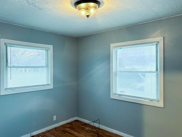 unfurnished room featuring dark hardwood / wood-style floors