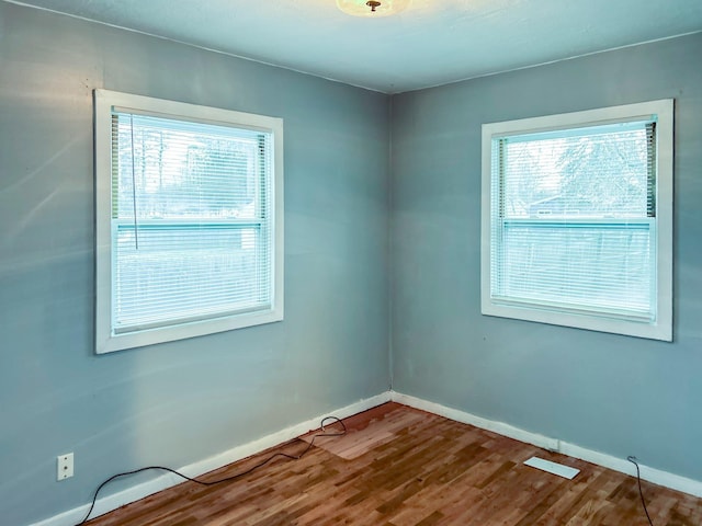 unfurnished room featuring wood-type flooring