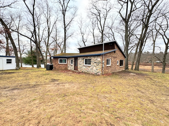 back of property with a lawn