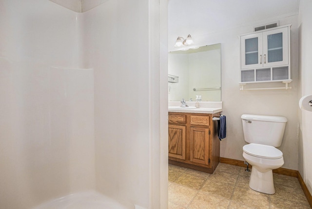 bathroom featuring tile patterned floors, walk in shower, vanity, and toilet