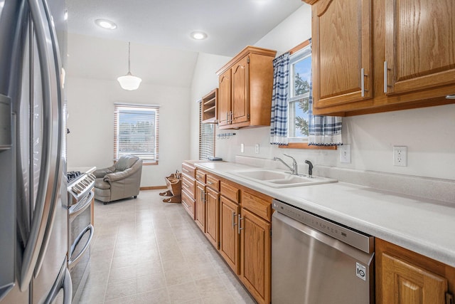 kitchen featuring sink, hanging light fixtures, vaulted ceiling, light tile patterned flooring, and appliances with stainless steel finishes