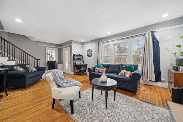 living room with a healthy amount of sunlight and light hardwood / wood-style floors