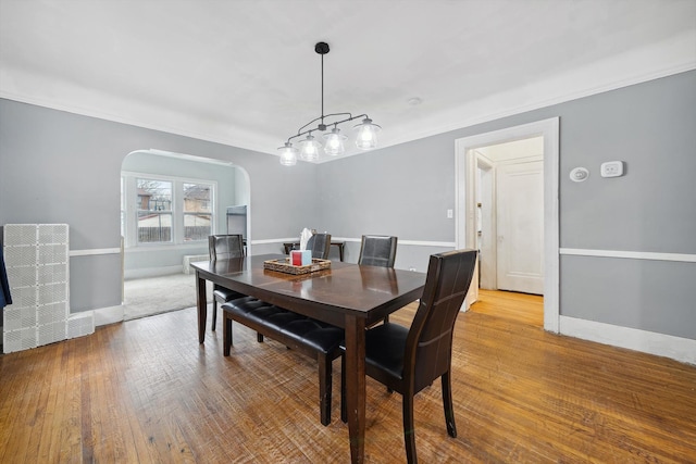 dining space featuring hardwood / wood-style flooring and crown molding