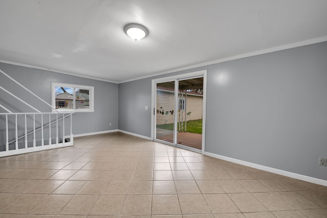 unfurnished room featuring crown molding, plenty of natural light, and light tile patterned floors