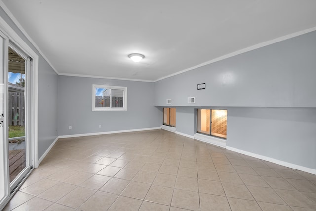 empty room with crown molding and light tile patterned floors