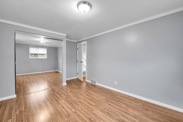 interior space with light wood-type flooring and ornamental molding