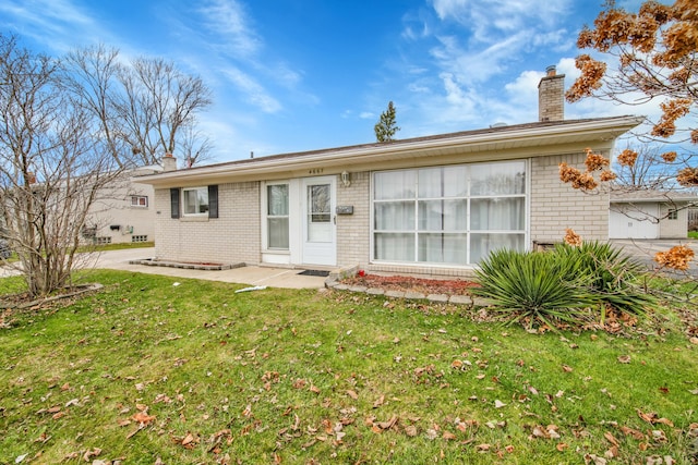 back of property featuring a lawn