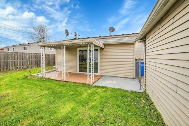 back of property with a patio and a lawn