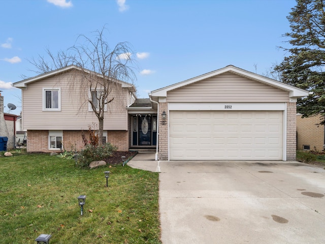 view of front of house with a front yard and a garage