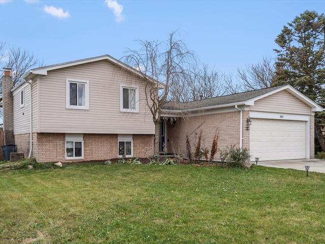 tri-level home with a garage and a front yard