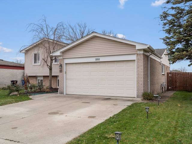 view of front of house featuring a front lawn and a garage