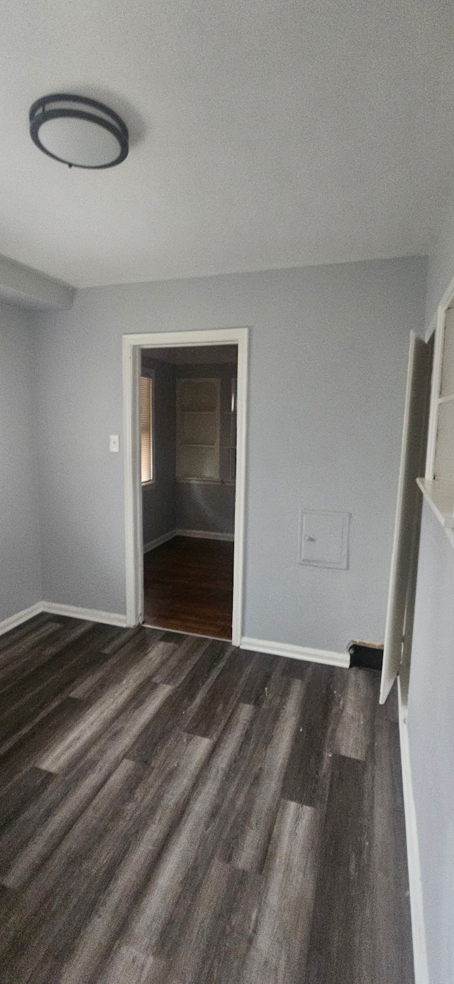 spare room with dark hardwood / wood-style floors and a textured ceiling