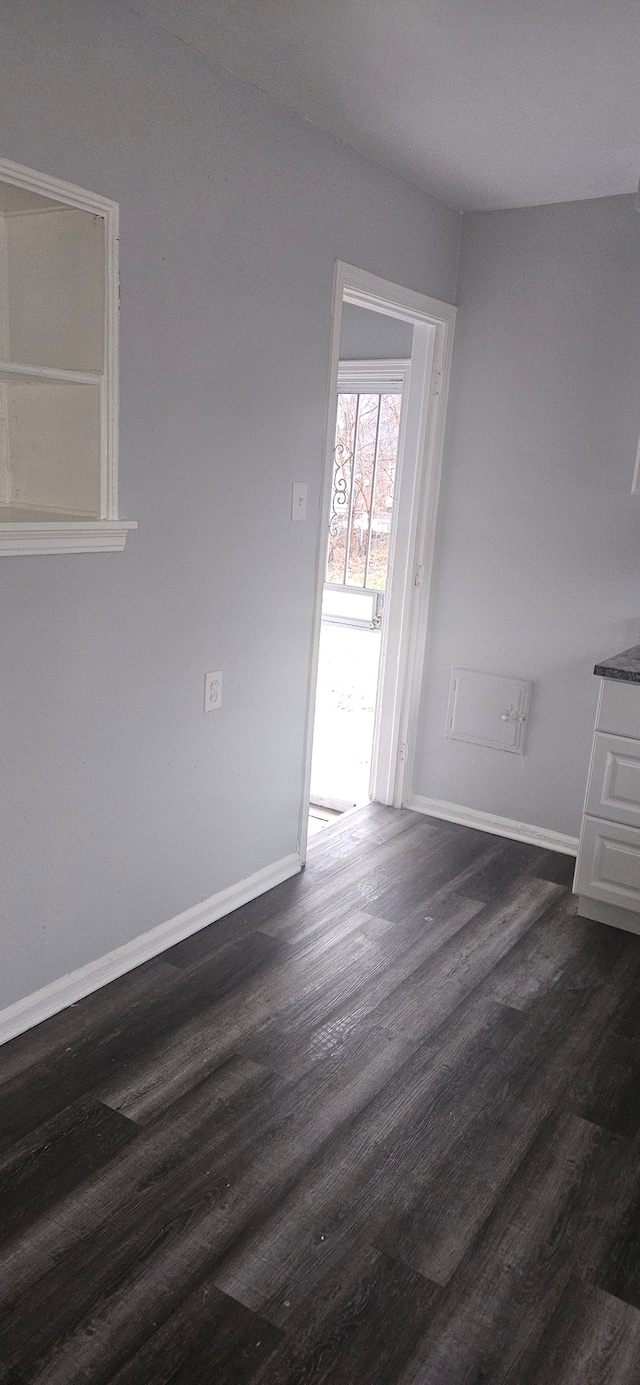 empty room with dark hardwood / wood-style floors