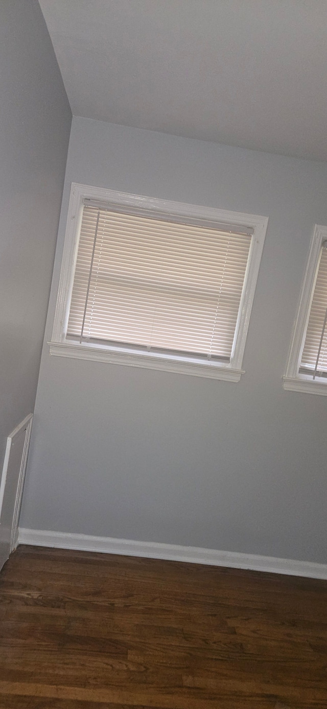 spare room featuring dark wood-type flooring