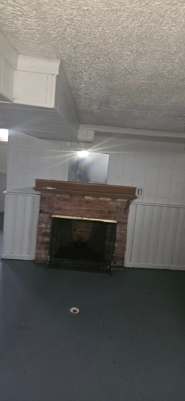 unfurnished living room featuring concrete floors and a textured ceiling