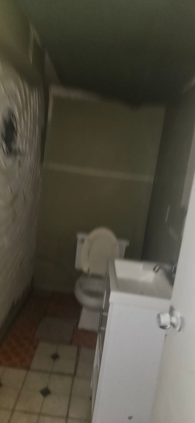 bathroom featuring tile patterned floors, vanity, and toilet