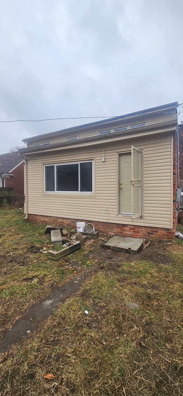 rear view of property featuring entry steps